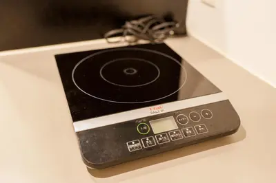 a cell phone on a table with a cord at Space F Yoyogi in Tokyo