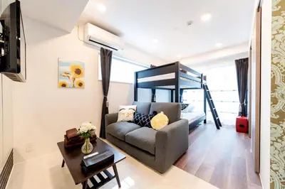 a living room with a couch and a bunk bed at Space F Yoyogi in Tokyo