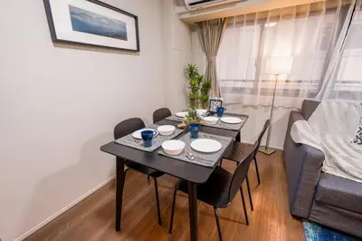 a dining room with a black table and chairs at HIZ HOTEL Ginza in Tokyo