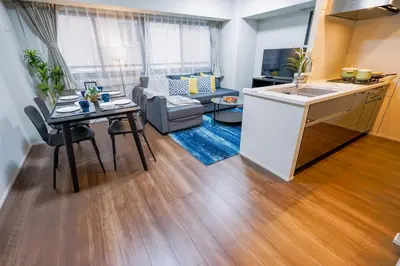 a kitchen and a living room with a table at HIZ HOTEL Ginza in Tokyo