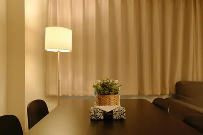 a table with a potted plant on it with a lamp at HIZ HOTEL Ginza in Tokyo
