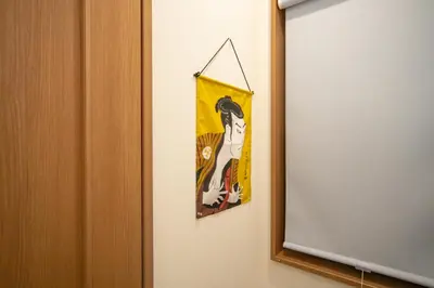 a towel hanging on a wall next to a mirror at Sumida-ku - House - Vacation STAY 82129 in Tokyo