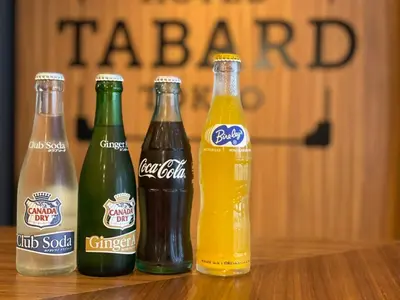 a group of four soda bottles sitting on a table at HOTEL TABARD TOKYO in Tokyo
