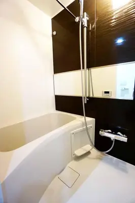 a white bath tub in a bathroom with a shower at Itos Ebisu in Tokyo