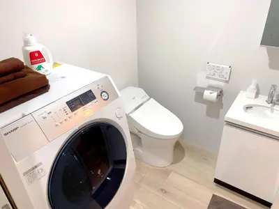 a washing machine in a bathroom with a toilet at Itos Ebisu in Tokyo