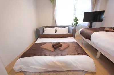 a bedroom with two beds with towels on them at LUANA in BELUBEE in Tokyo
