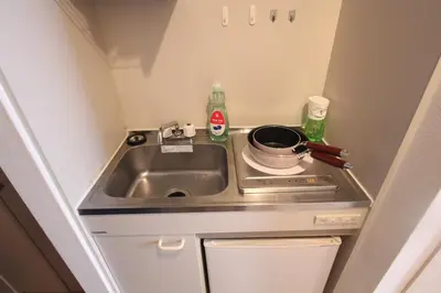 a small kitchen with a sink and a stove at LUANA in BELUBEE in Tokyo