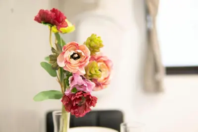 a vase filled with colorful flowers on a table at Hill Side Terrace Hiroo Shibuya 102 in Tokyo