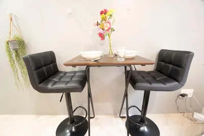 two chairs and a table with a vase of flowers at Hill Side Terrace Hiroo Shibuya 102 in Tokyo