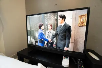 a television screen with a man and a woman at Hill Side Terrace Hiroo Shibuya 102 in Tokyo