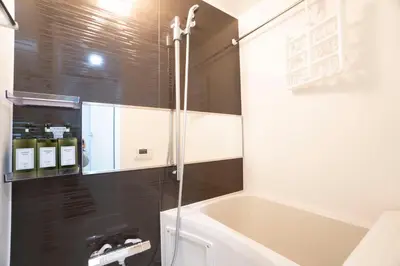 a bathroom with a shower and a bath tub at Hill Side Terrace Hiroo Shibuya 102 in Tokyo