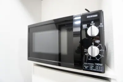a black microwave oven with a person inside at Hill Side Terrace Hiroo Shibuya 203 in Tokyo