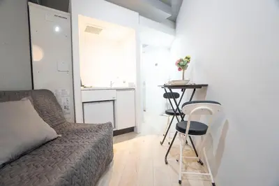 a small bedroom with a bed and a table at Hill Side Terrace Hiroo Shibuya 203 in Tokyo