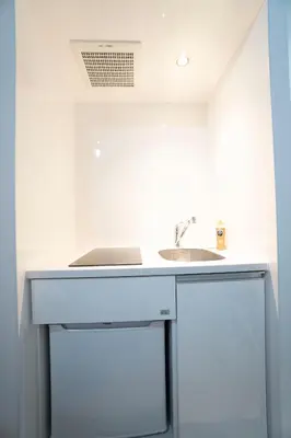 a white kitchen with a sink and a dishwasher at Hill Side Terrace Hiroo Shibuya 103 in Tokyo
