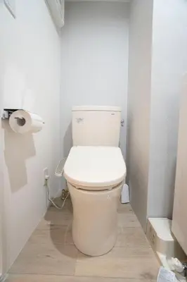 a white toilet in a bathroom with a roll of toilet paper at Hill Side Terrace Hiroo Shibuya 103 in Tokyo