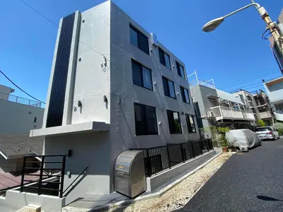a building with a mailbox on the side of a street at Hill Side Terrace Hiroo Shibuya 103 in Tokyo