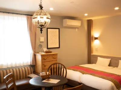 a hotel room with a bed and a table and a desk at 7 Rooms Hotel & Cafe - Boutique Designer Hotel - 30 mins from Disneyland&Tokyo in Tokyo