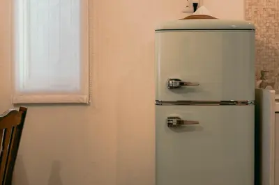 an old refrigerator in the corner of a kitchen at 7 Rooms Hotel & Cafe - Boutique Designer Hotel - 30 mins from Disneyland&Tokyo in Tokyo