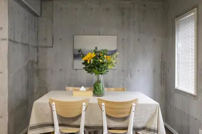 a dining room with a table with a vase of flowers at Uhome Otsuka Villa in Tokyo
