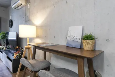 a wooden table with two chairs and a lamp at Uhome Otsuka Villa in Tokyo