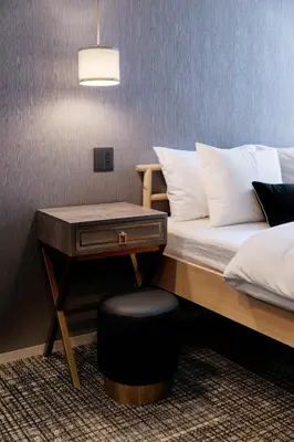 a bedroom with a bed with a table and a stool at The Barn Tokyo in Tokyo