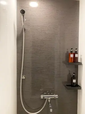 a shower with a shower head in a bathroom at The Barn Tokyo in Tokyo