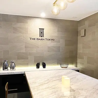 a kitchen with a counter with a sign on the wall at The Barn Tokyo in Tokyo