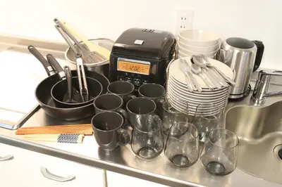 a kitchen counter with coffee cups and a toaster at Hikari House in Tokyo
