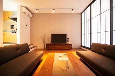 a living room with two couches and a television at ENGAWA & GIVE Nakano in Tokyo