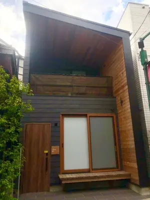 a building with two white doors on the side of it at ENGAWA & GIVE Nakano in Tokyo