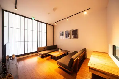 a living room with a couch and a table at ENGAWA & GIVE Nakano in Tokyo