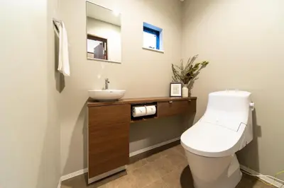 a bathroom with a white toilet and a sink at ENGAWA & GIVE Nakano in Tokyo