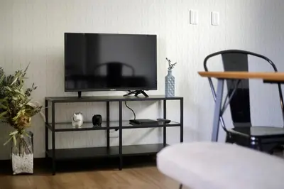 a flat screen tv sitting on a black entertainment center at Villa Belle-Vue Kanegafuchi in Tokyo