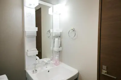 a white bathroom with a sink and a mirror at Villa Belle-Vue Kanegafuchi in Tokyo