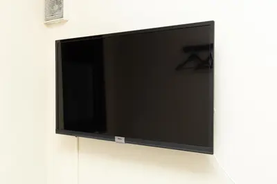 a flat screen tv hanging on a wall at Gennoya in Tokyo
