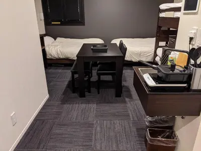 a small room with a table and a bed at Gennoya in Tokyo