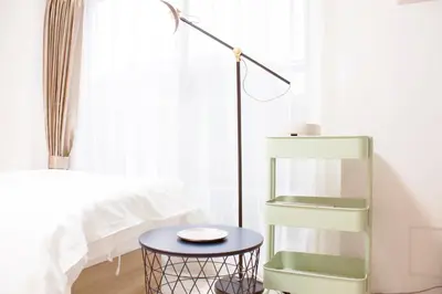 a bedroom with a green book shelf next to a bed at Hotel Shu in Tokyo