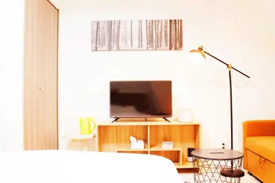 a living room with a television and a couch at Hotel Shu in Tokyo