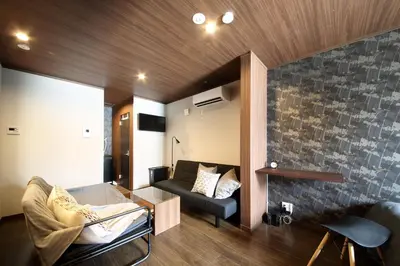 a living room with a couch and a fireplace at s-rea TOKYO 201 in Tokyo