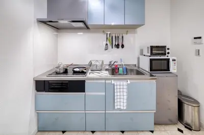 a kitchen with a sink and a microwave at Diamond Moon Palace Takadanobaba,2 stops to Shinjuku in Tokyo