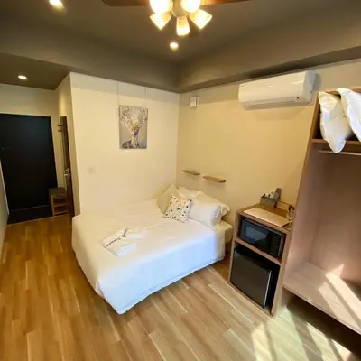 a small room with a bed and a table at Kainoa Guesthouse in Tokyo