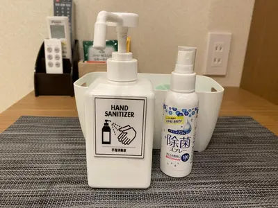 two bottles of hand sanitizer sitting on a table at Kainoa Guesthouse in Tokyo