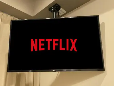 a television screen with the netflix logo on it at Kainoa Guesthouse in Tokyo