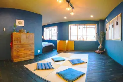 a room with a bedroom with a bed and blue walls at Indigo flat in Asakusa in Tokyo