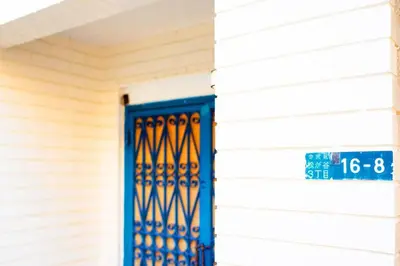 a blue door on a house with a street sign at Indigo flat in Asakusa in Tokyo