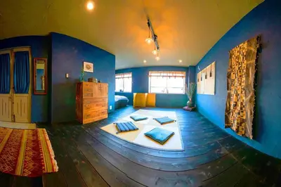 a large room with blue walls and a bed with pillows at Indigo flat in Asakusa in Tokyo