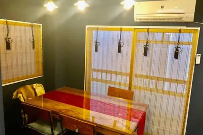 a dining room with a table with a colorful curtain at Indigo flat in Asakusa in Tokyo