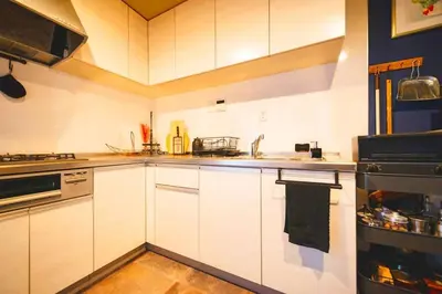a kitchen with white cabinets and a sink at Indigo flat in Asakusa in Tokyo