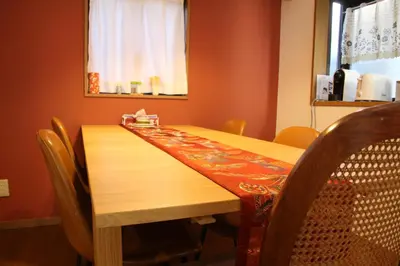 a dining room table with chairs and a wooden table sidx sidx at HAMA HILLS Shinjuku in Tokyo