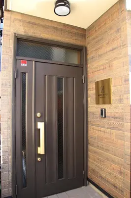 a door to a building with a sign above it at HAMA HILLS Shinjuku in Tokyo